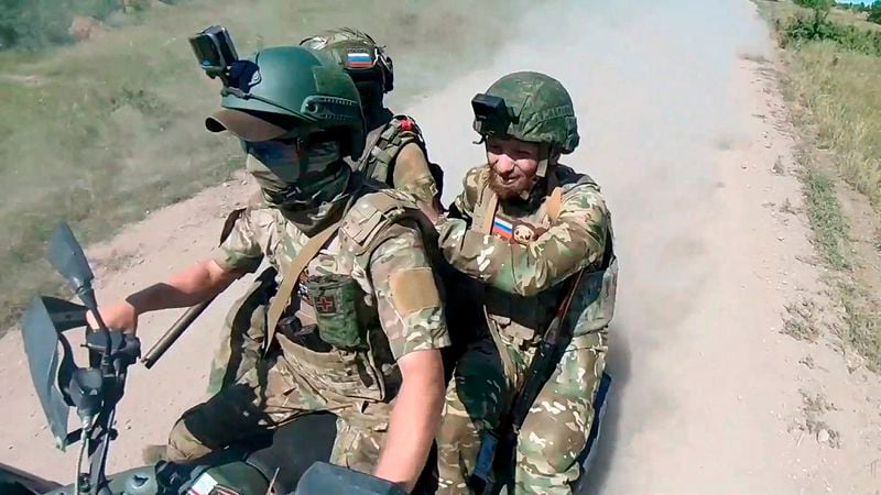 In this photo, taken from video released by the Russian Defense Ministry Press Service on Monday, July 1, 2024, Russian soldiers ride a quad bike changing their positions at the frontline in an undisclosed location in Ukraine. (Russian Defense Ministry Press Service via AP, File)