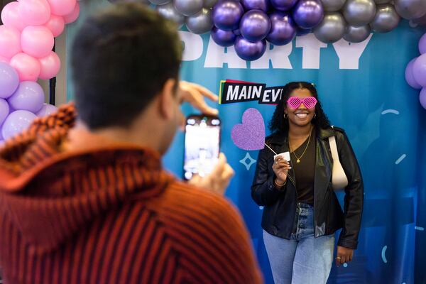 Dhruv Alexander snaps a photo of Myiya Peters at the “Pitch a Friend” dating event on Tuesday, February 11, 2025, at Main Event in Atlanta. Attendees came from across metro Atlanta to pitch their single friends to other singles. CHRISTINA MATACOTTA FOR THE ATLANTA JOURNAL-CONSTITUTION. 