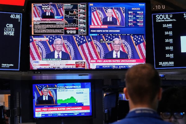 Screens on a trading post on the floor of the New York Stock Exchange show the news conference of Federal Reserve Chair Jerome Powell, Wednesday, May 7, 2025. (AP Photo/Richard Drew)