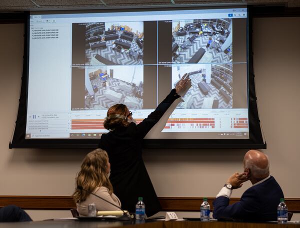 Jacki Pick points out what she considered suspicious activity on surveillance video of the Fulton County absentee vote counting room as she and Rudy Giuliani address a subcommittee of the state Senate judiciary committee at the State Capitol on Thursday, Dec. 3, 2020. (Ben Gray for The Atlanta Journal-Constitution)