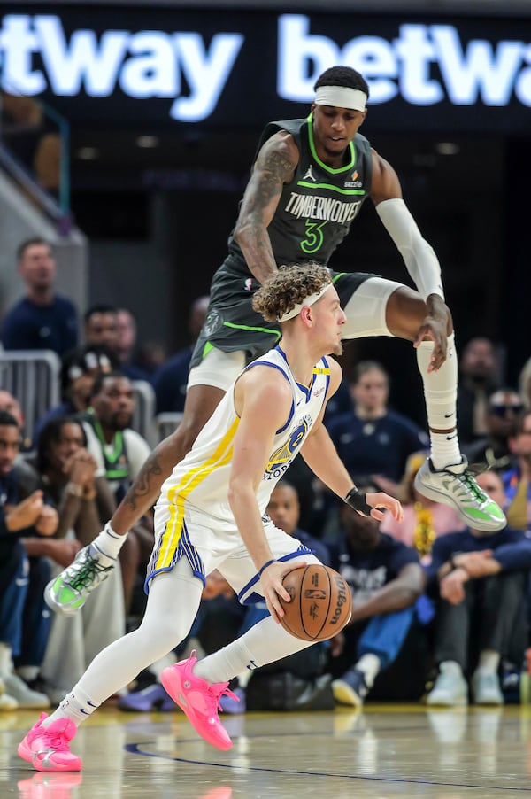 Jaden McDaniels (3) of Minnesota Timberwolves leaps to defend againt Brandin Podziemski (2) of the Golden State Warriors in the first half in Game 3 of the Conference Semifinals of the NBA Playoffs at Chase Center in San Francisco., on Saturday, May 10, 2025.(Carlos Avila Gonzalez/San Francisco Chronicle via AP)