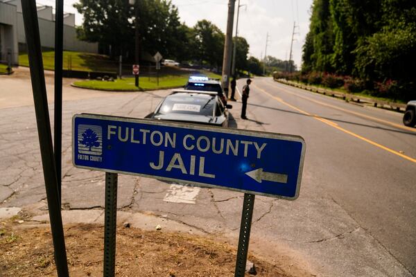FILE - A Fulton County Jail signs points to where the jail is located, Aug. 24, 2023, in Atlanta. (AP Photo/Brynn Anderson, File)