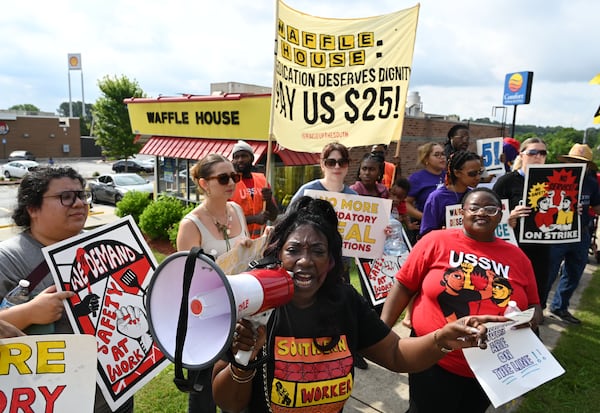 Lakesha Buckley (center), an organizer with USSW, led the rally to demand $25-an-hour wages and improved security outside a Waffle House on Windy Hill Road.