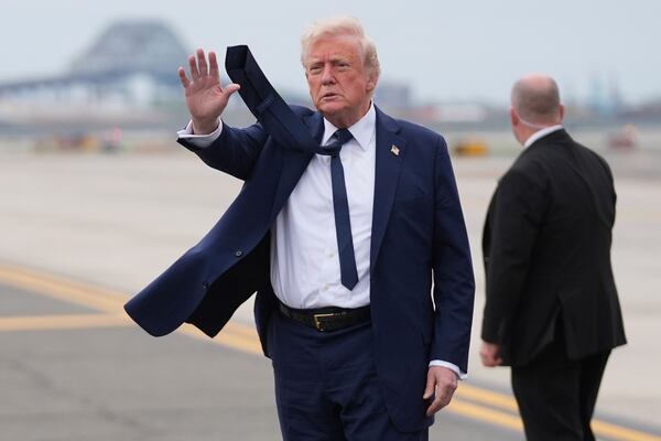 President Donald Trump waves as he arrives at Newark Liberty International Airport in Newark, N.J., Saturday, April 26, 2025, upon returning from a trip to attend the funeral of Pope Francis at the Vatican. (AP Photo/Evan Vucci)