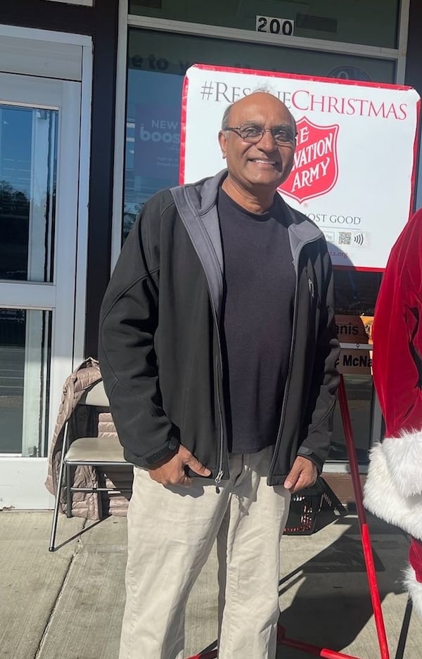 Mahendra Patel, here ringing the bell with the Salvation Army, was arrested by Acworth police last month after a young mother said he tried to snatch her young son from her lap in a Walmart. Patel's attorney says facts are being twisted to make him look sinister. (Courtesy)