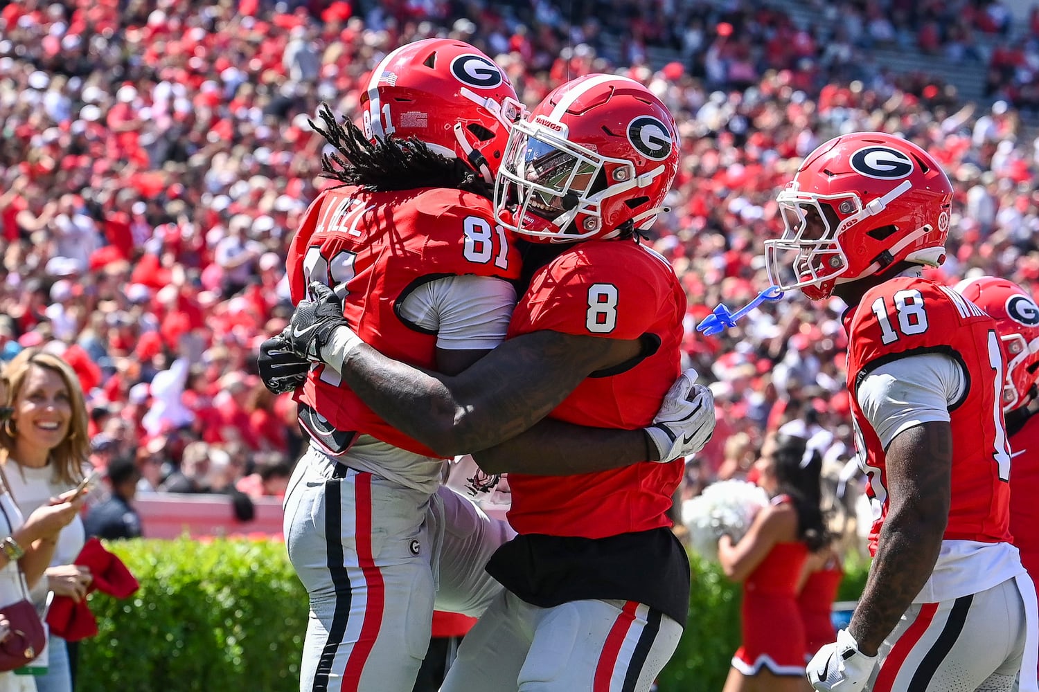 Georgia’s Red Team Colbie Young (8) celebrates with teammate Jeremy Bell (81) after Bell scores a touchdown during the second half of the G-Day spring football game Saturday, April 12, 2025 at Sanford Stadium in Athens. (Daniel Varnado/For the Atlanta Journal-Constitution)