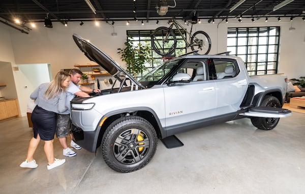 Christian and Katana Brunkow check out the front trunk of a Rivian R1T in the new Rivian “space” at Avalon in Alpharetta on Friday, April 4, 2025. (Bita Honarvar for The Atlanta Journal-Constitution)