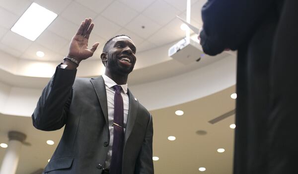Everton Blair takes an oath during his swearing in ceremony at the Gwinnett County Board of Education office in Suwanee, Ga., on Thursday, Dec. 20, 2018. (AJC file photo)