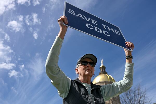 Holly Williams, a retired Centers for Disease Control and Prevention (CDC) worker, holds a sign in support of the CDC during the "Stand Up for Science" rally on Friday, March 7, 2025 at the Georgia State Capitol. (Daniel Varnado/For the Atlanta Journal-Constitution)