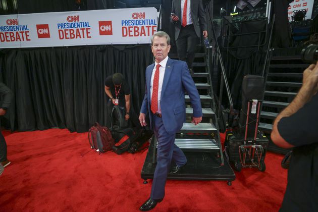 Gov. Brian Kemp walks down stairs after he was interviewed by a media member at the Media Filing Center at McCamish Pavilion, Thursday, June 27, 2024, in Atlanta. Later Thursday, President Joe Biden and former President Donald Trump face off during their first presidential debate at CNN. (Jason Getz / AJC)