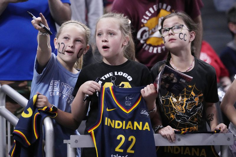 Young fans watch Indiana Fever guard Caitlin Clark warm up for the team's WNBA basketball game against the New York Liberty, Thursday, May 16, 2024, in Indianapolis. (AP Photo/Michael Conroy, File)