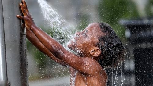 Isannah Brightwell, 5, frolicked in the water at Rodney Cook Sr. Park in Historic Vine City on June 15, 2023. (John Spink / John.Spink@ajc.com)