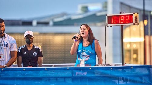 Rachel Norman performs the national anthem ahead of the 2022 Peachtree Road Race.