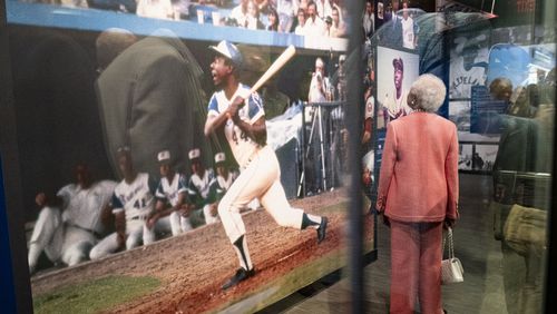 Billye Aaron, Hank Aaron's beloved wife, looks up at photos at the entrance of the Atlanta History Center exhibit “More Than Brave: The Life of Henry Aaron” on Monday, April 8, 2024.   (Ben Gray / Ben@BenGray.com)