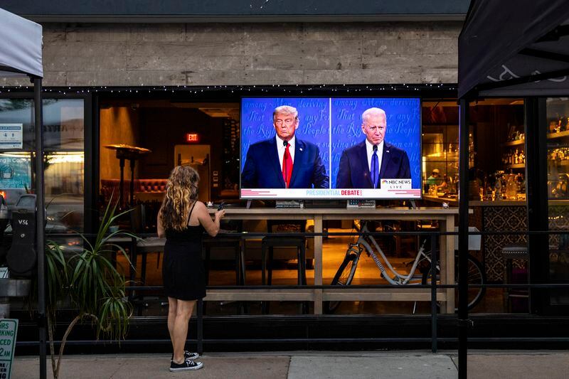 In this October 2020 file photo, a woman is seen watching a debate between then-President Donald Trump and former Vice President Joe Biden, who won the November election.